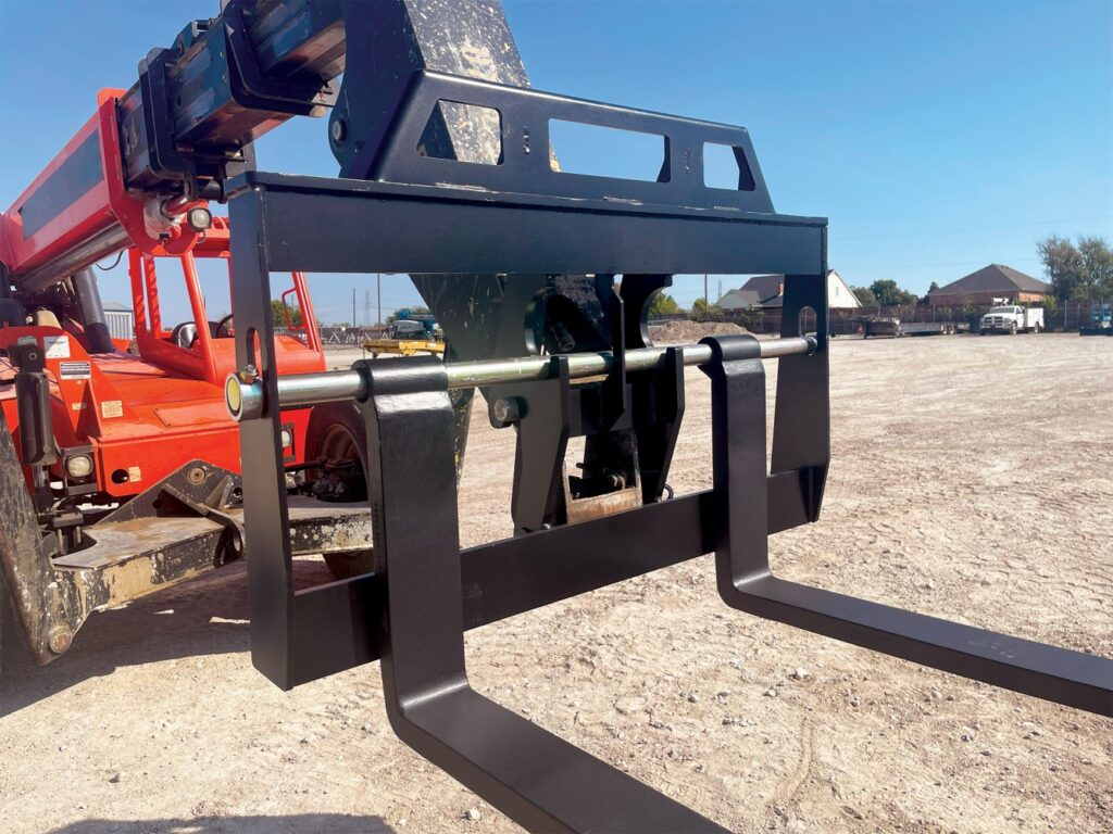Telehandler fork carriage with forklift forks installed on an active construction site